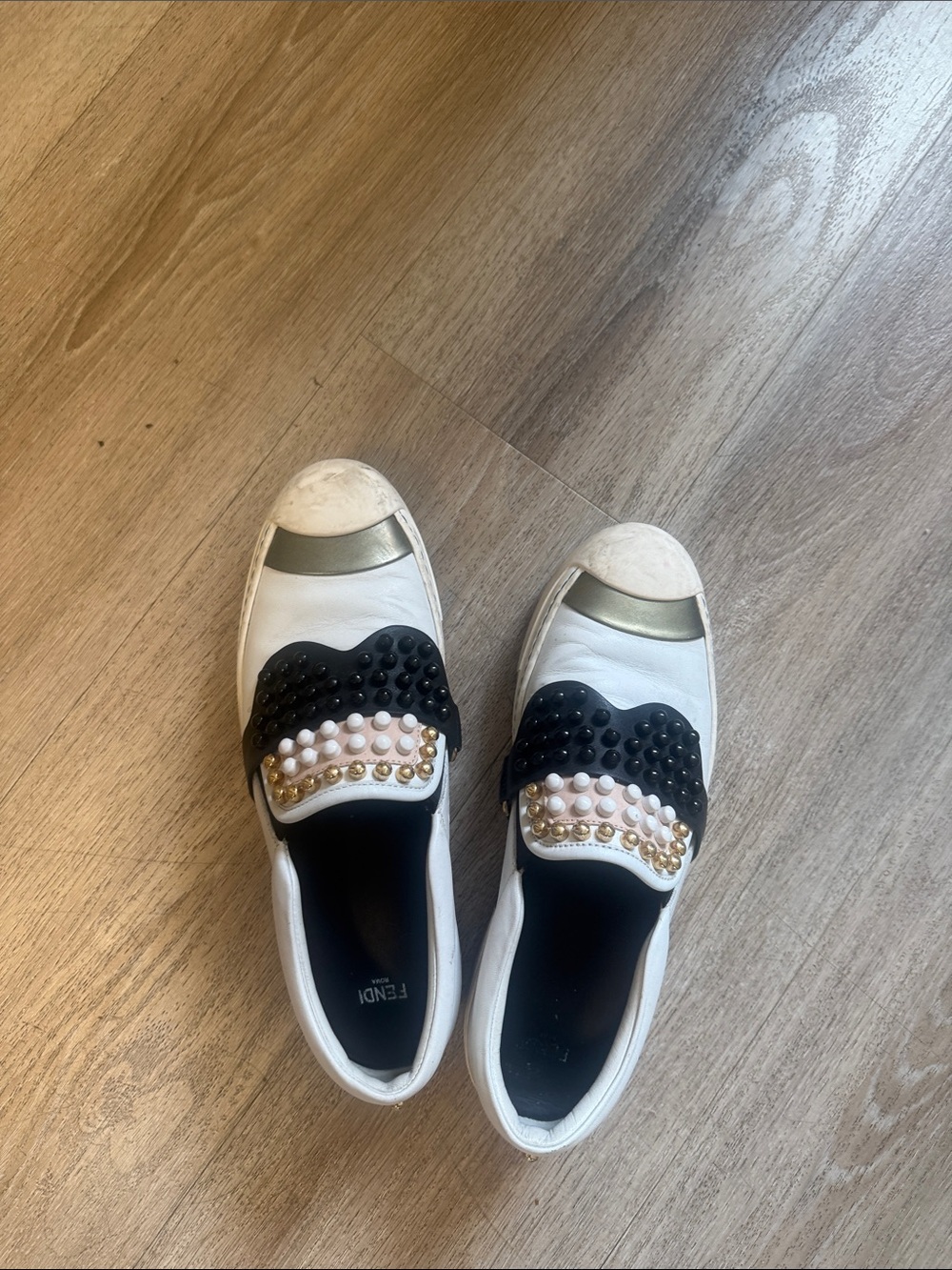 Fendi White Leather Slip-On Sneakers with Black & Gold Embellishments